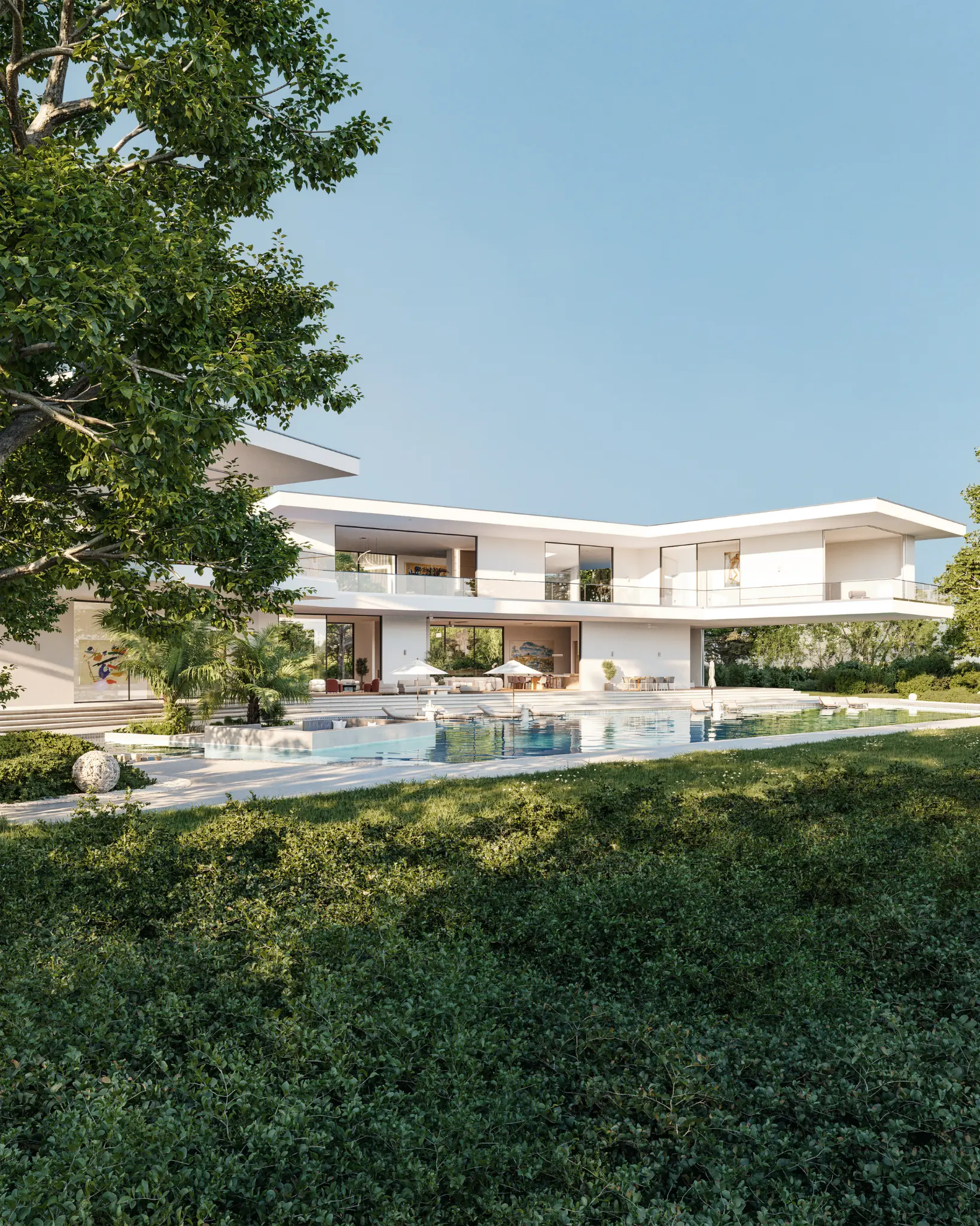 Contemporary white villa and pool framed by mature garden planting
