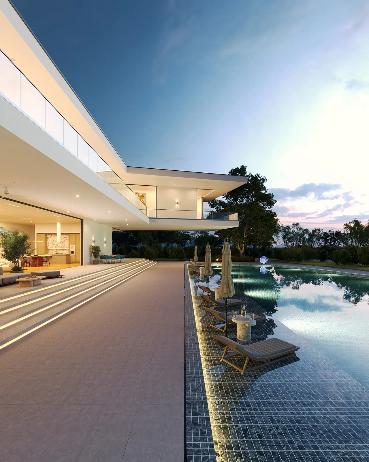 Dusk poolside view of a high-end contemporary residence